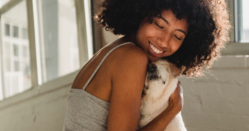 a woman holding a dog